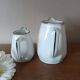 2 white porcelain milk jugs with platinum trim, Flora by Apilco.