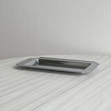 Small rectangular tray made of lightweight metal.