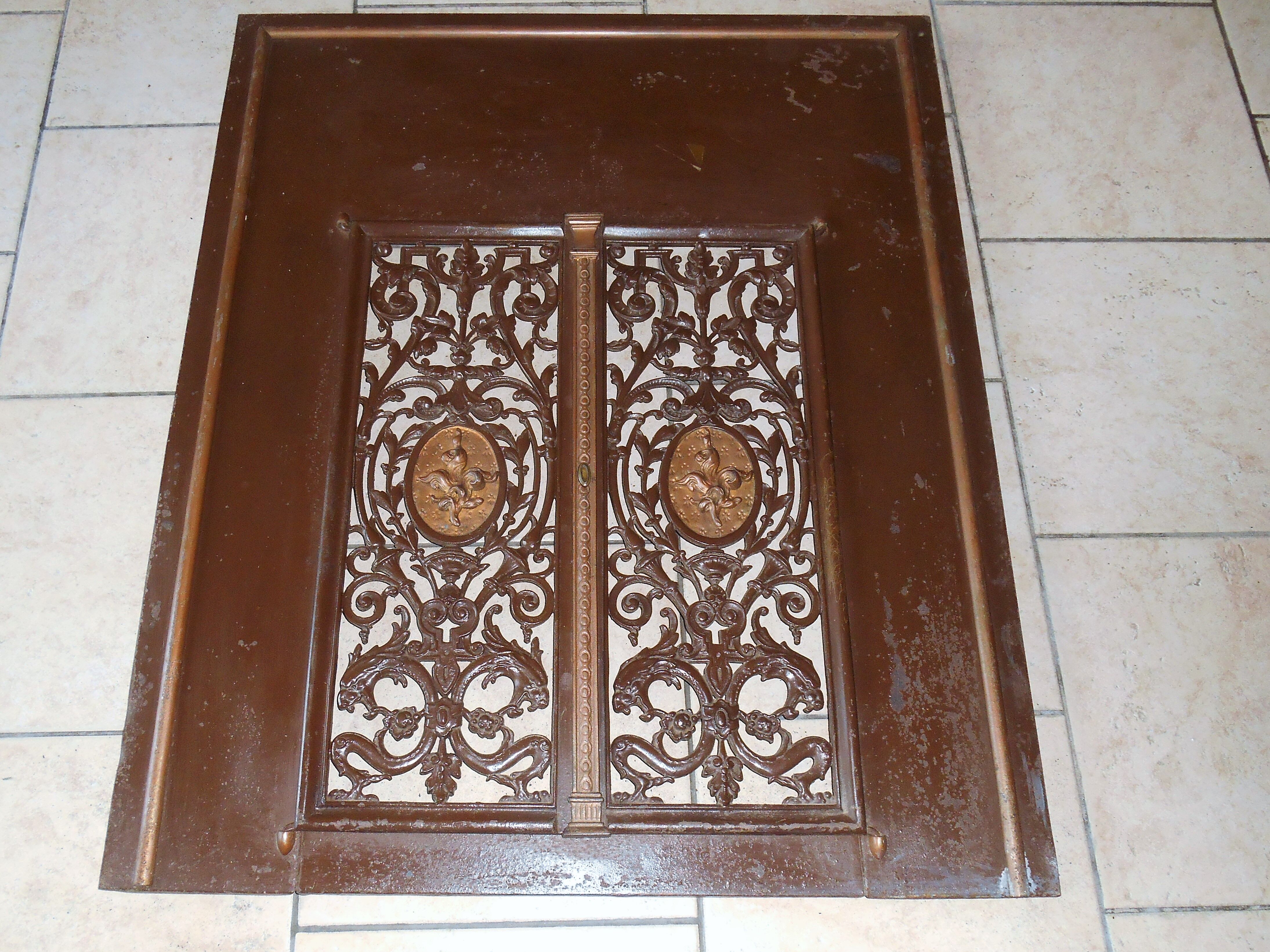 Pair of cast iron door grilles with its coat