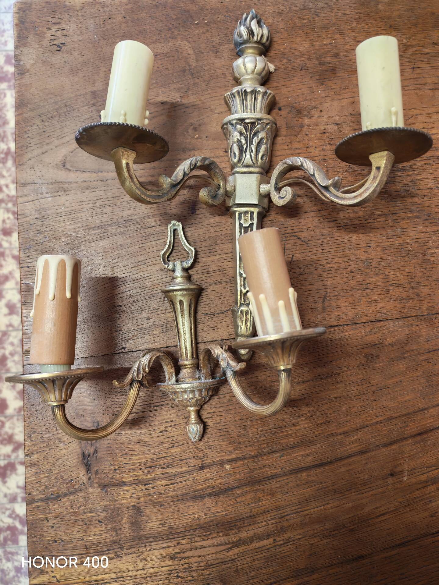 Two antique wall sconces in gilded bronze in the Louis XVI style.