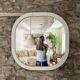 Large Space Age wall mirror in white-patinated wood. France, 1970s
