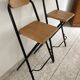 2 foldable bar stools from the 90s in wood and black metal
