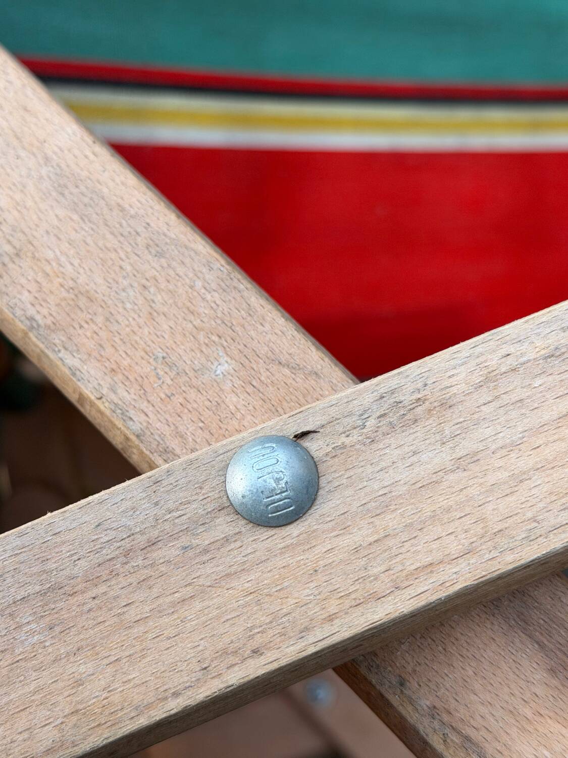 Vintage deck chair with striped green and red fabric, original patina.