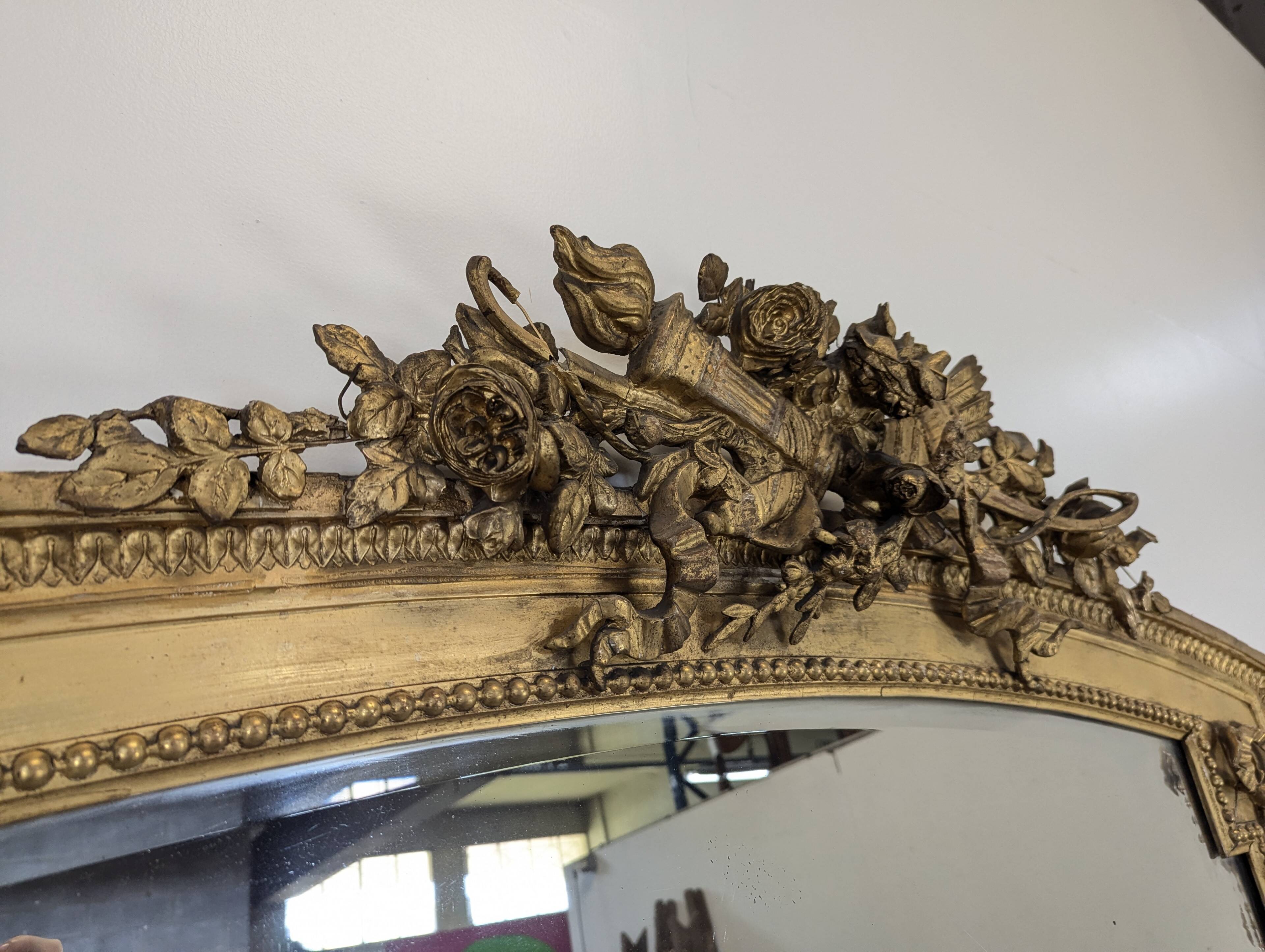 Large gilded wooden mirror in Louis XVI style from the late 19th century.