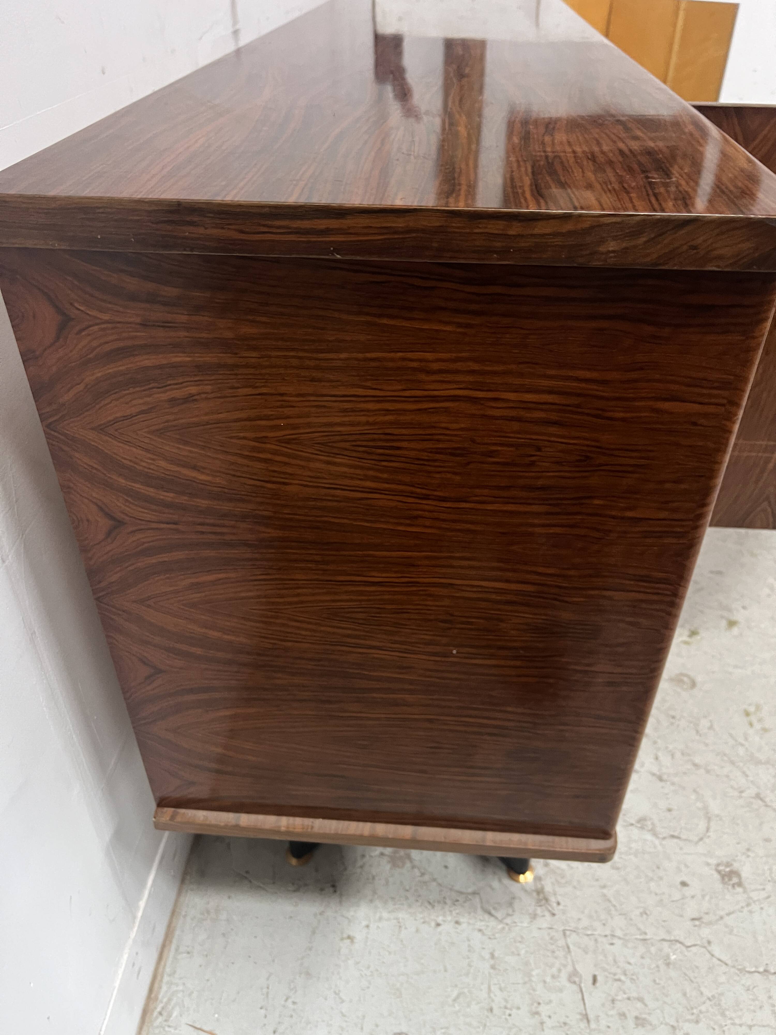 Scandinavian enfilade in veneered wood with iron legs, 20th century.