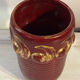 Mid-century relief vase in ruby red enhanced with gilding.