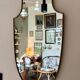 Miroir "écusson" avec cadre en métal doré 86 x 50 cm