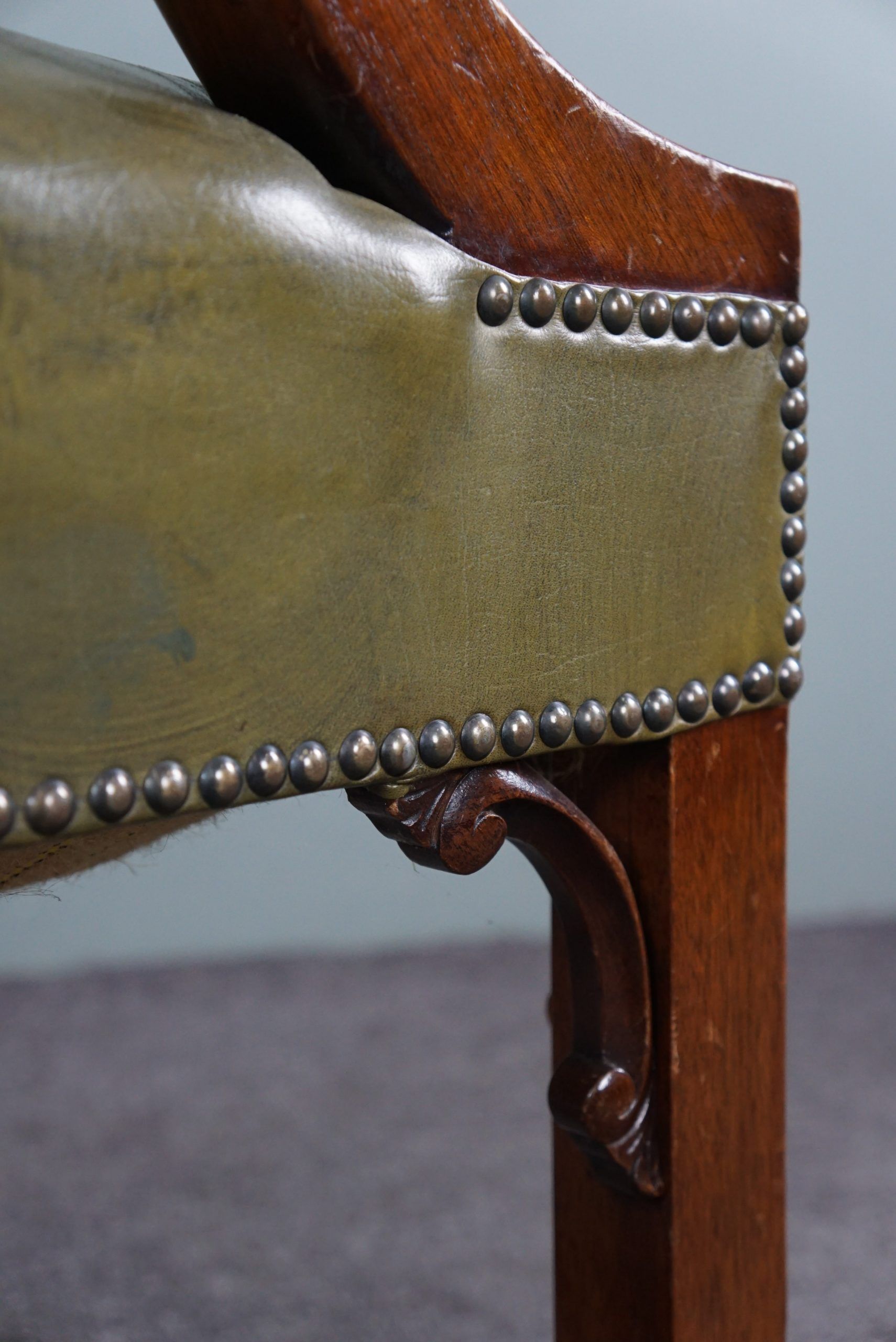 Elegant armchair and footrest in English green leather