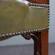 Elegant armchair and footrest in English green leather