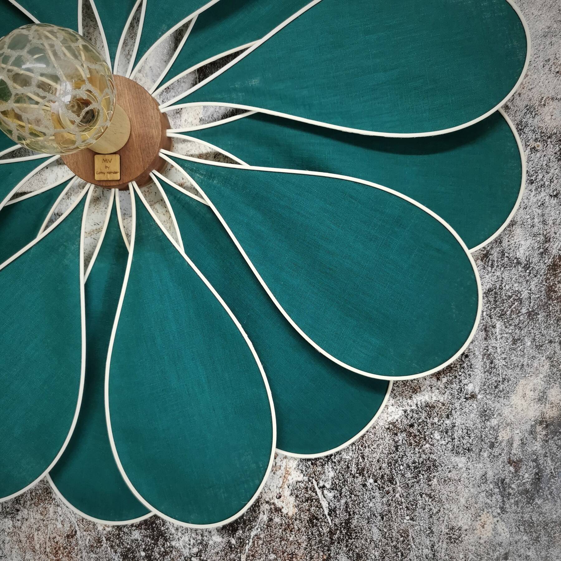 Emerald green rattan and linen flower wall light with 16 petals