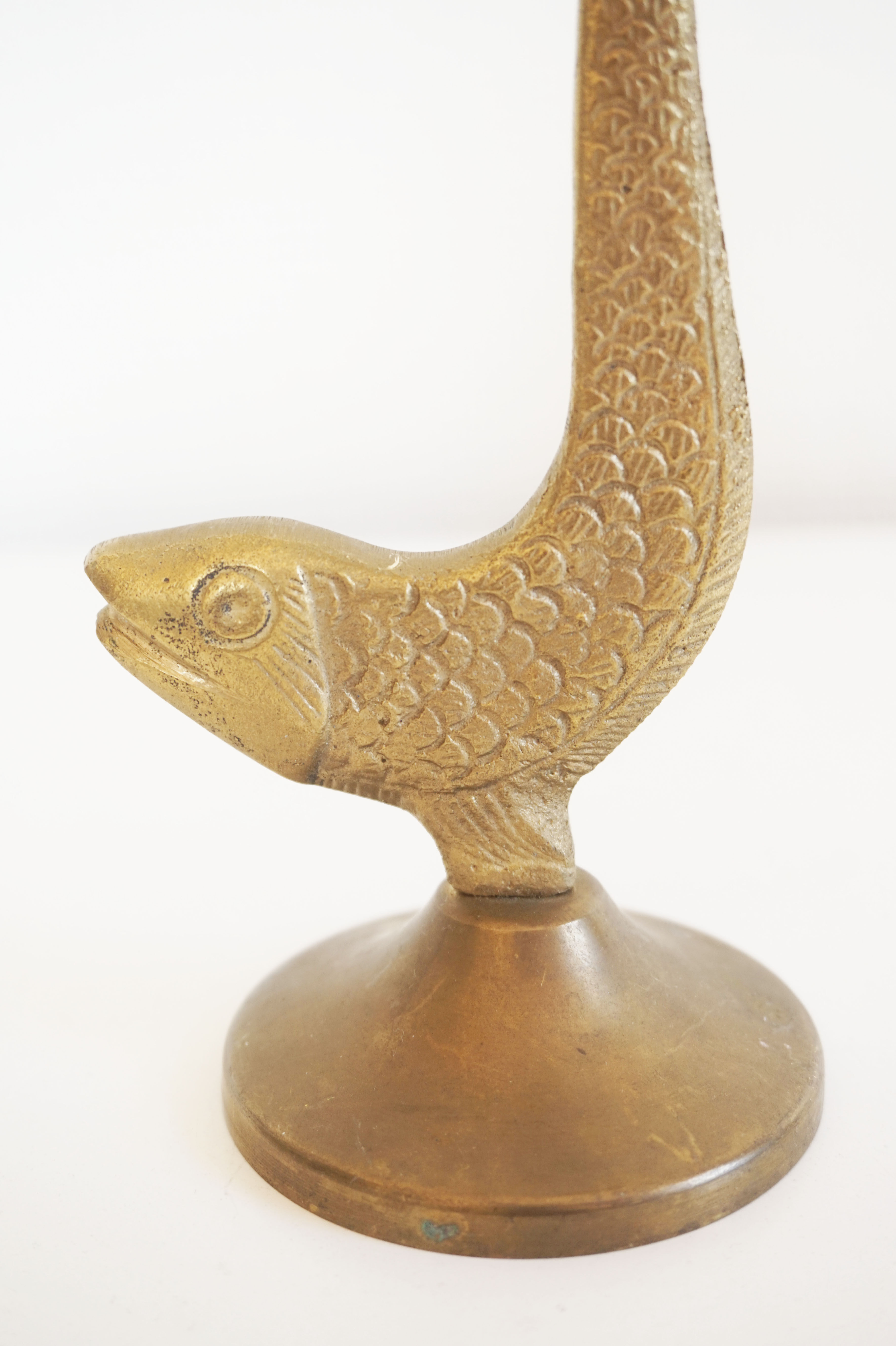 Old golden brass fish candlestick
