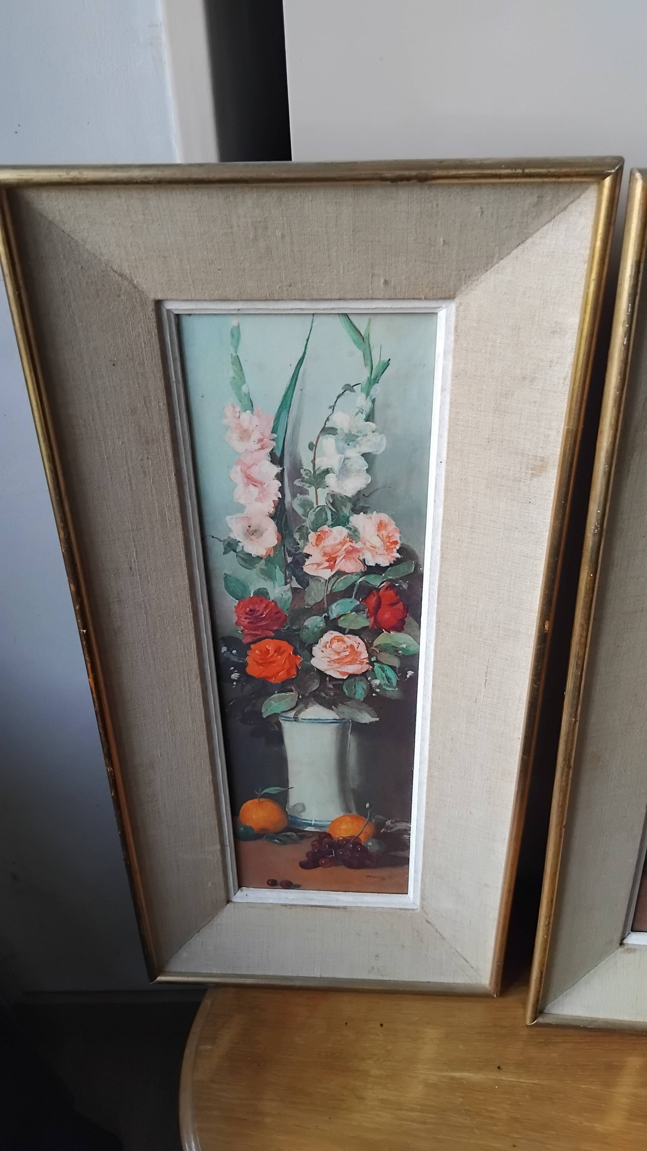 Pair of framed paintings featuring a composition of flowers.