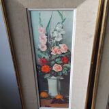 Pair of framed paintings featuring a composition of flowers.