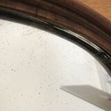 Old oval mirror with wooden frame