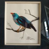 Framing a blue bird in feathers and painting