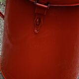 Red enamelled metal bin from the 1950s, with a lockable lid and side handles.