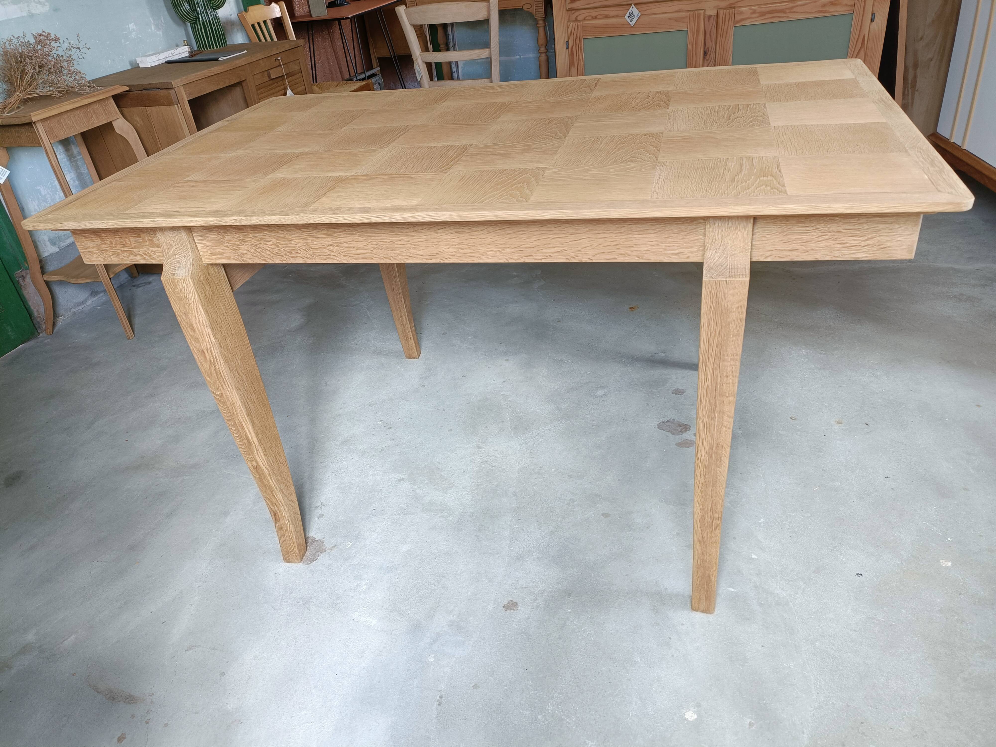 Oak dining table with a checkerboard top and extensions.