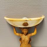 Wall lamp, where the base is a carved wooden lady holding the shade which is made of alabaster 1920s