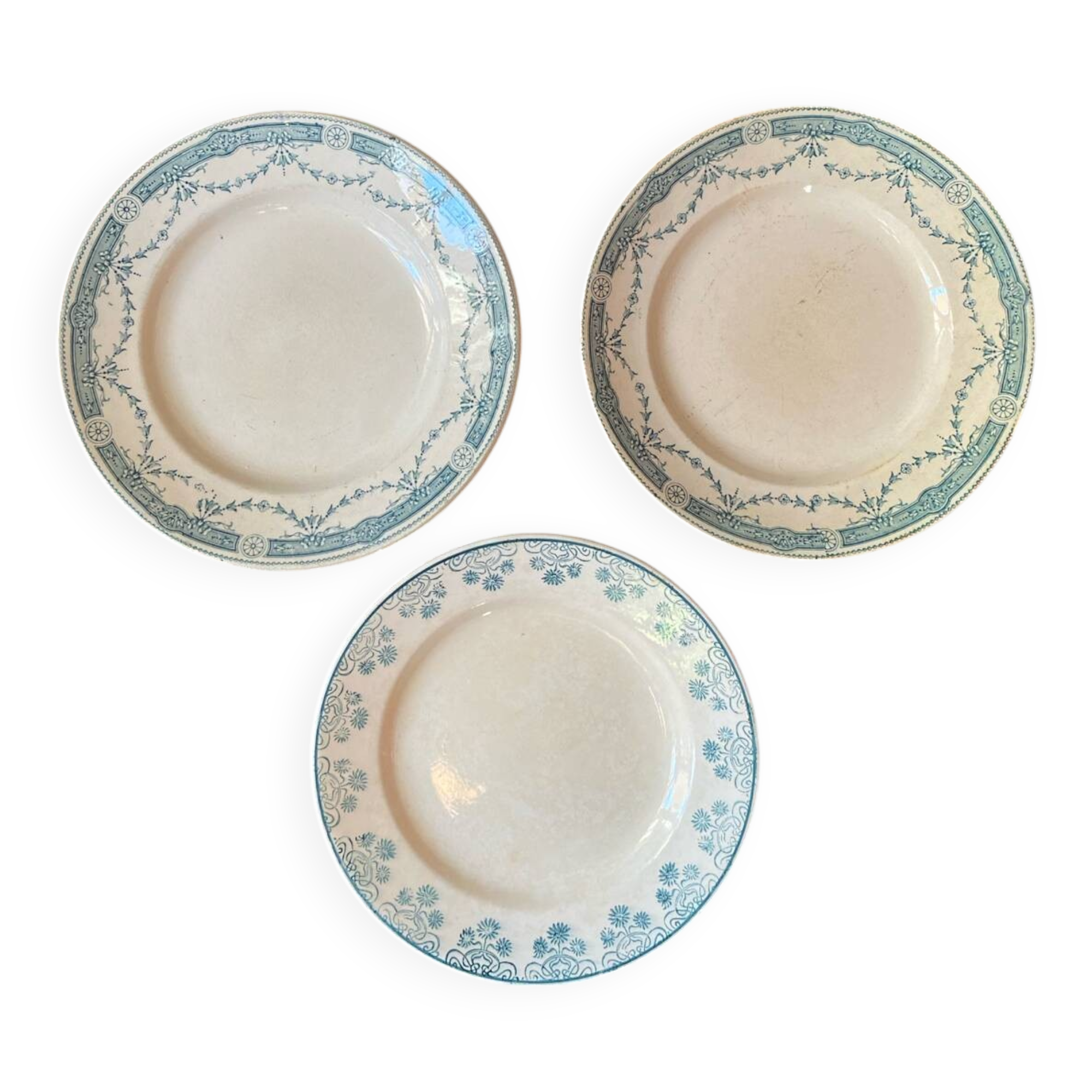3 flat plates in ironstone with a floral green border.