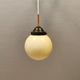 Small Art Deco hanging lamp in cream coloured glass and bakelite top.
