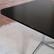 70s design coffee table with a black top and steel legs.