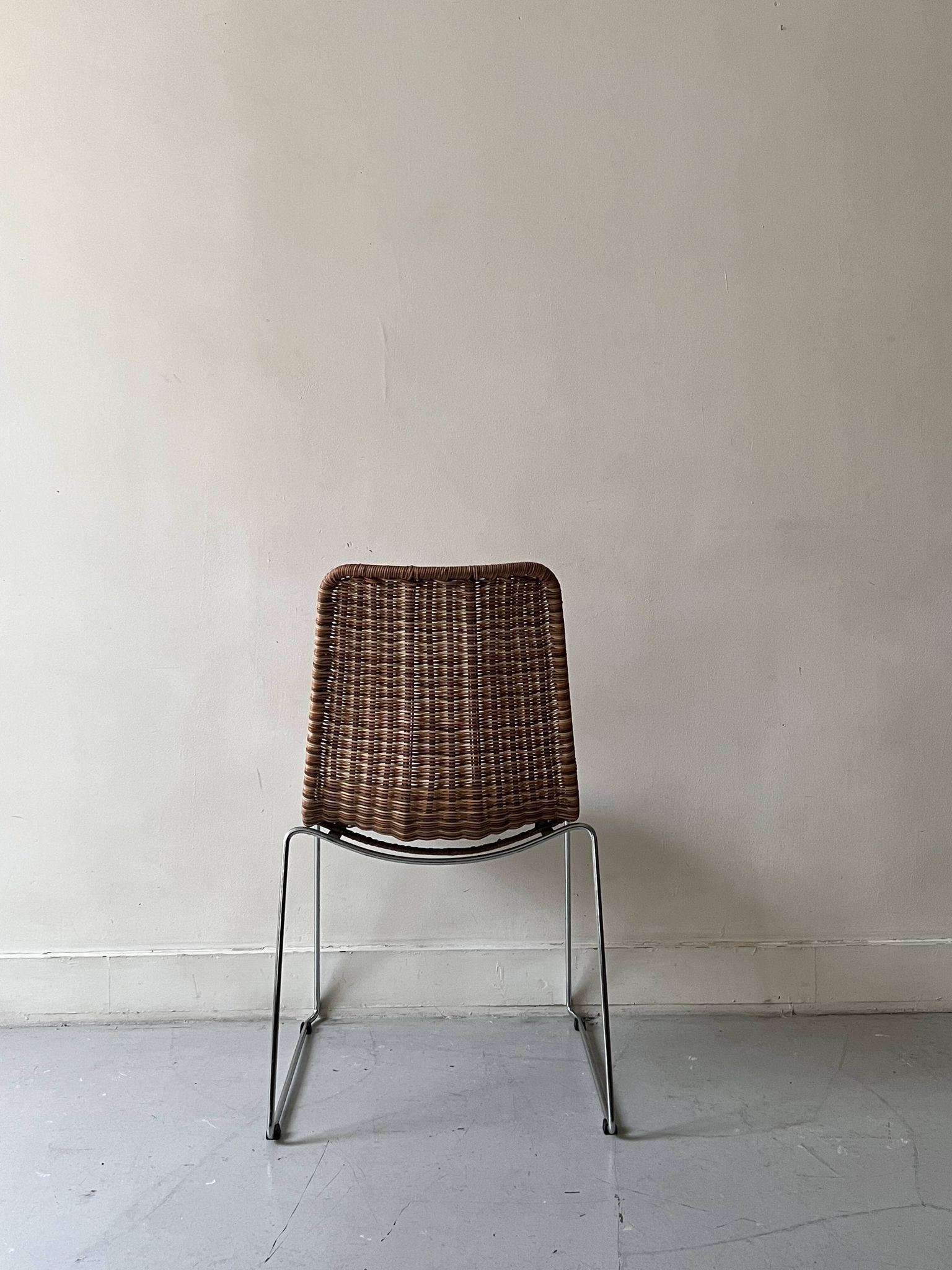 Chair design in rattan, woven wicker and chrome wire metal.