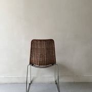 Chair design in rattan, woven wicker and chrome wire metal.