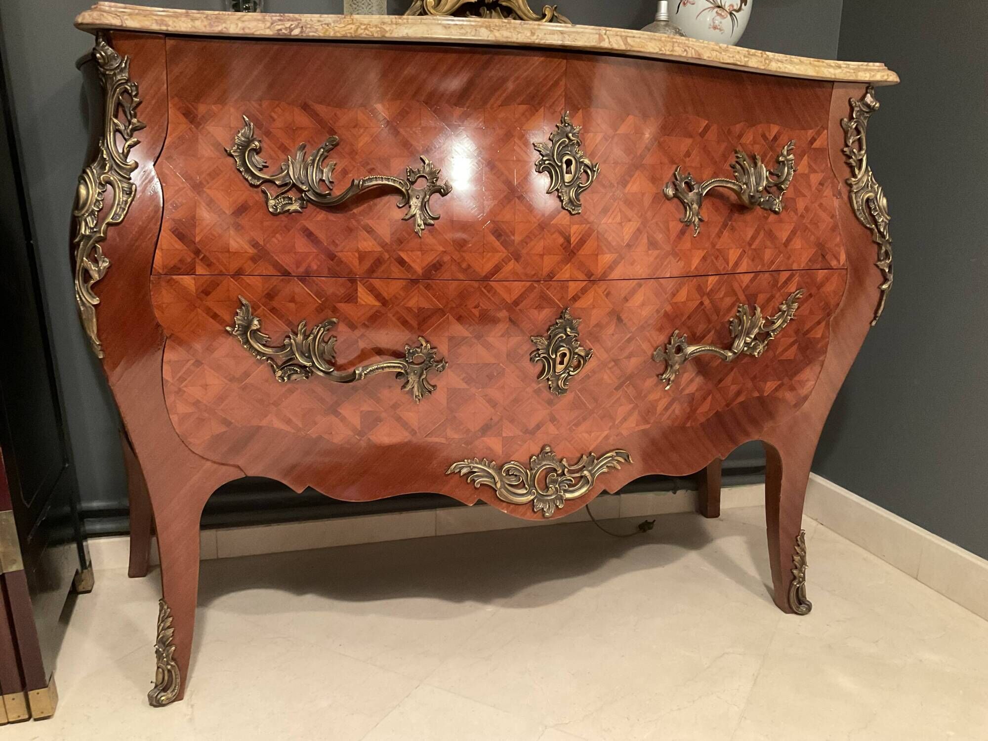 Curved commode with marquetry and marble top.