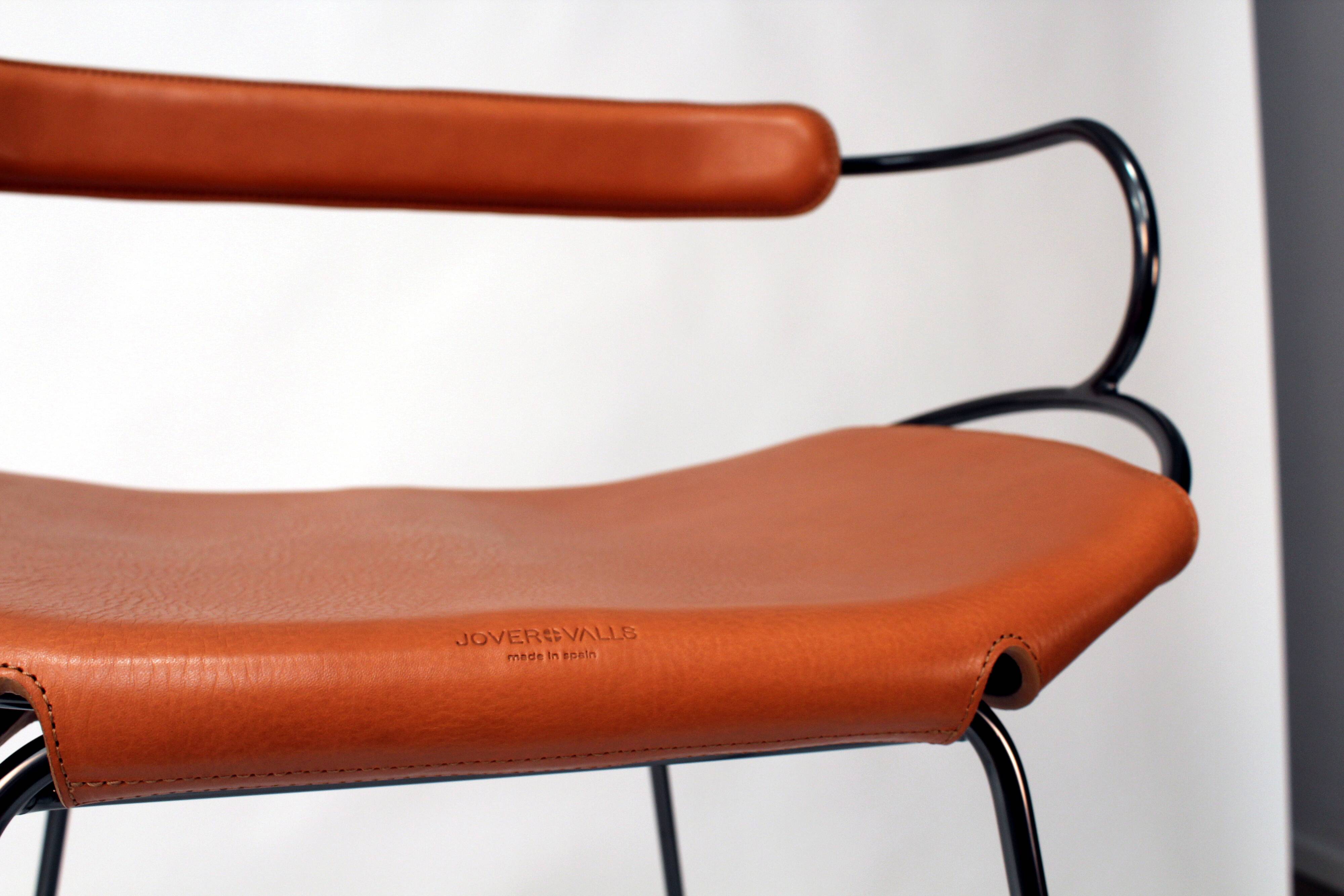 Table height stool with a backrest in aged silver metal and natural tan leather.