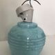 Wall light in ceramic with a light blue glass globe.