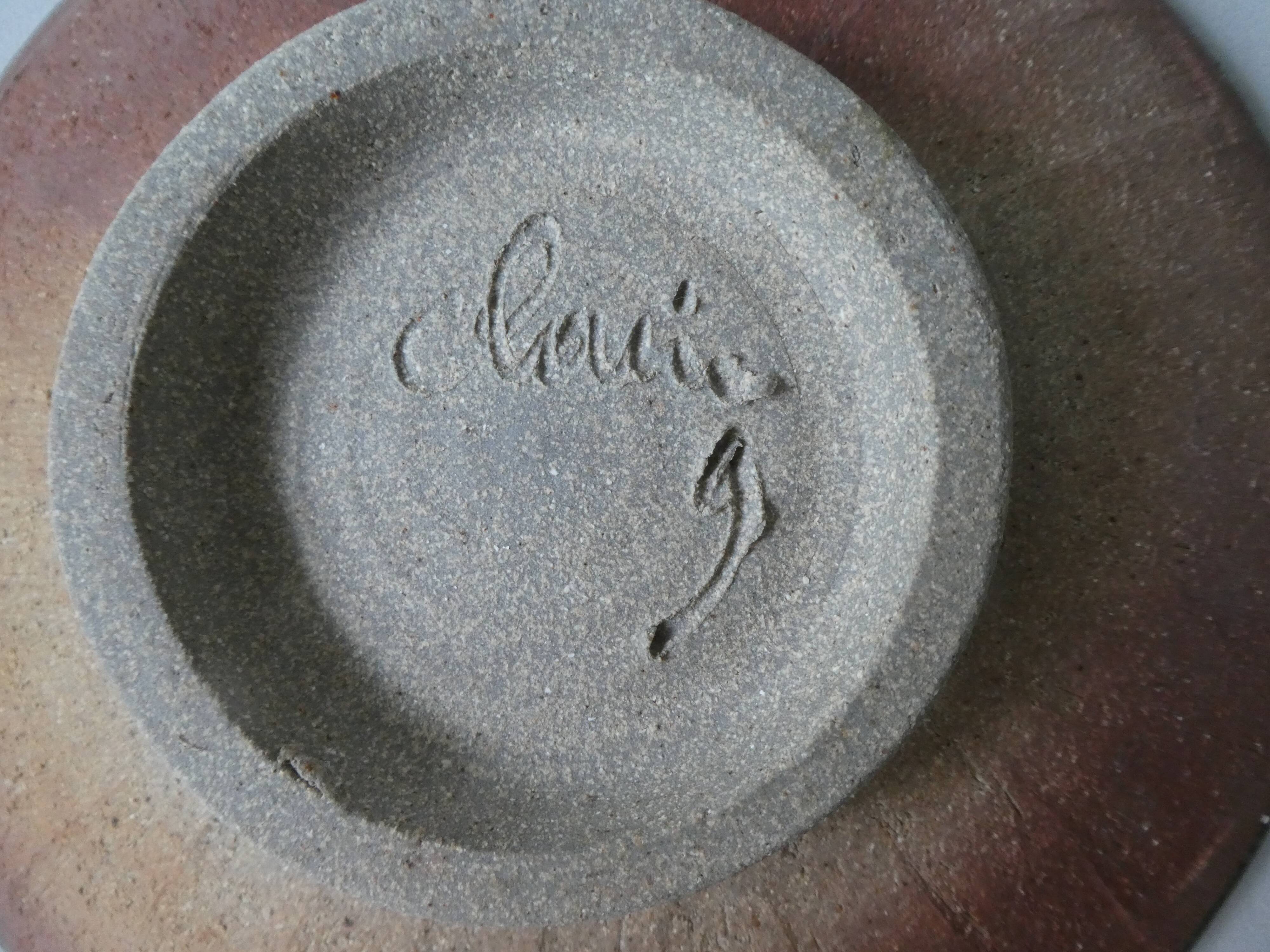 Flat, cut on peedouche, enamelled sandstone, signed