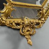 Antique octagonal mirror in richly carved gilded wood, Louis XV style.