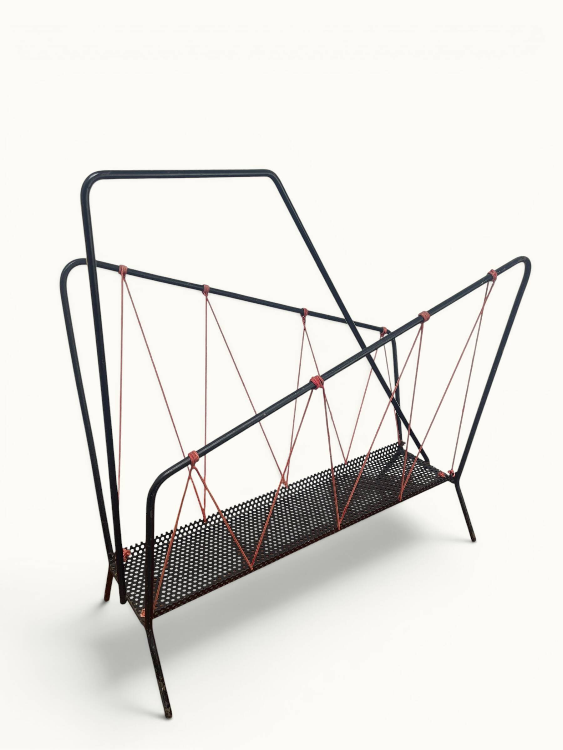 Vintage perforated metal magazine rack with cord handles by Matégot from the 1950s-60s.