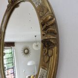 Oval wall mirror, golden floral pattern in stucco and wood, late 19th century