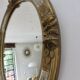 Oval wall mirror, golden floral pattern in stucco and wood, late 19th century