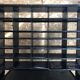 Old black metal postal sorting furniture + 30 perforated lockers + vintage stool