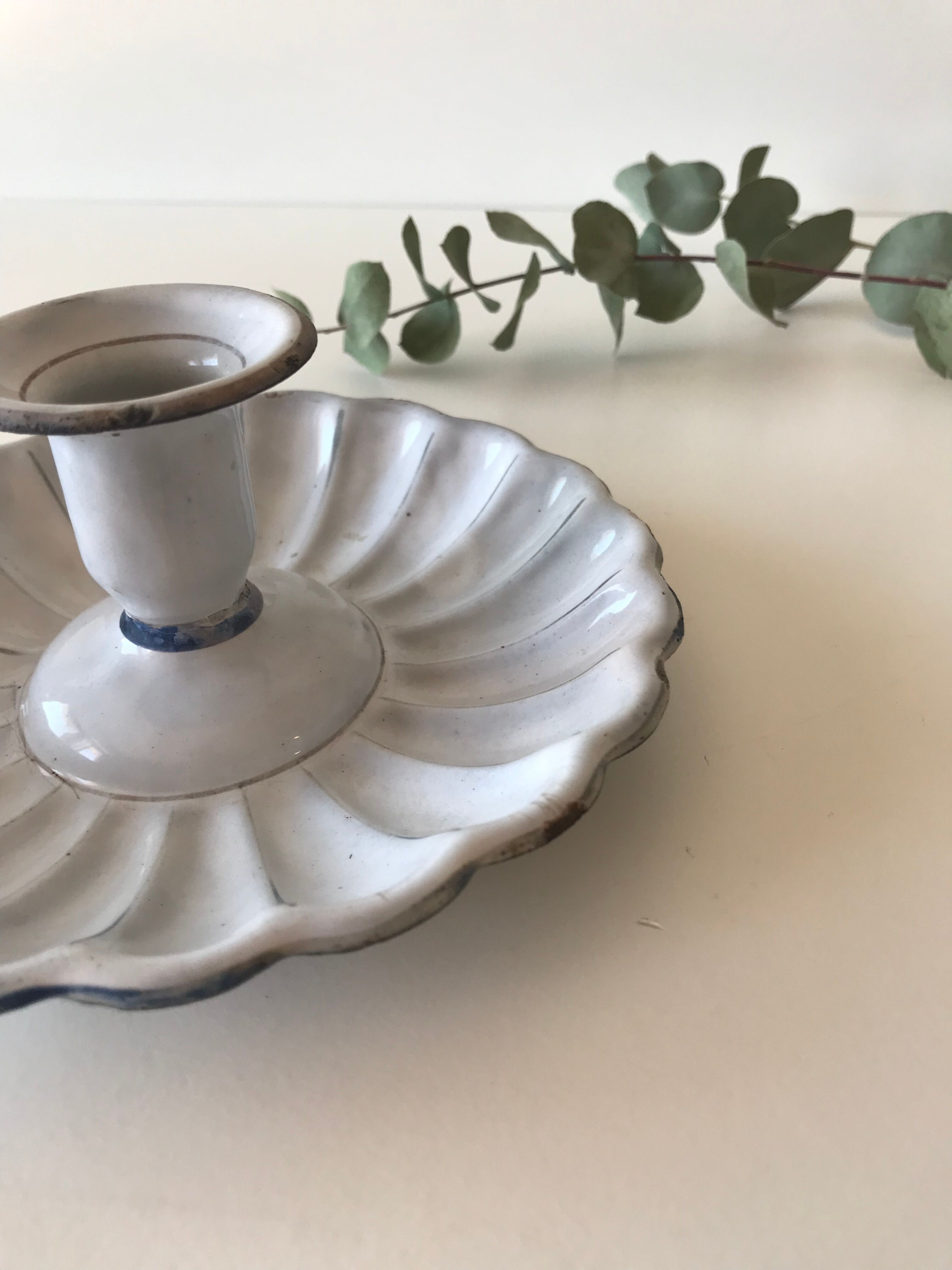 Candlestick in white enameled metal