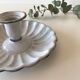 Candlestick in white enameled metal