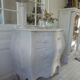 Curved patinated chest of drawers pearl grey waxed finish