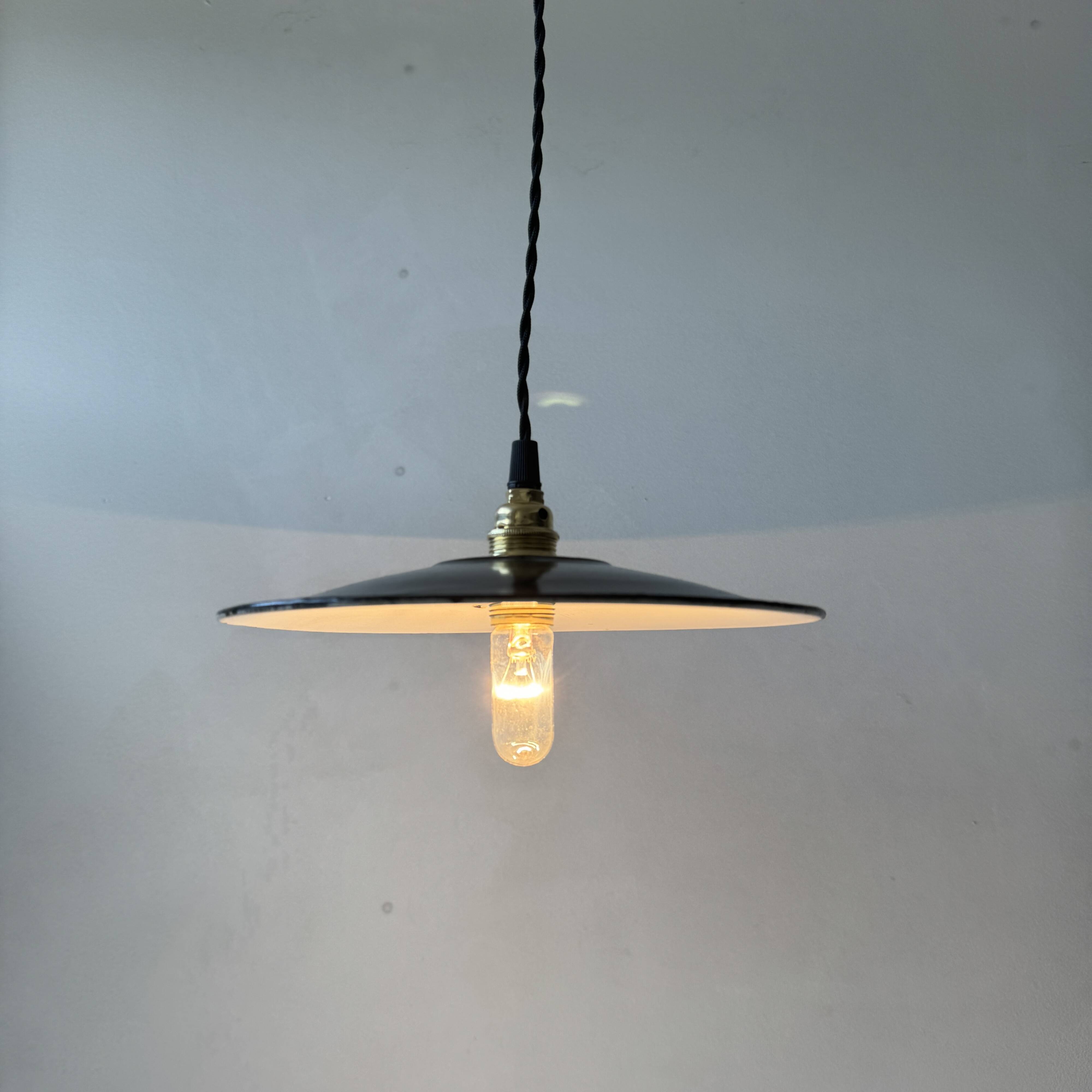 Pair of old industrial black enamelled pendant lights