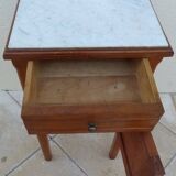 Antique bedside table with its marble top and white earthenware interior