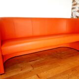 Curved vintage orange canapé with a pop spirit, seventies design piece.