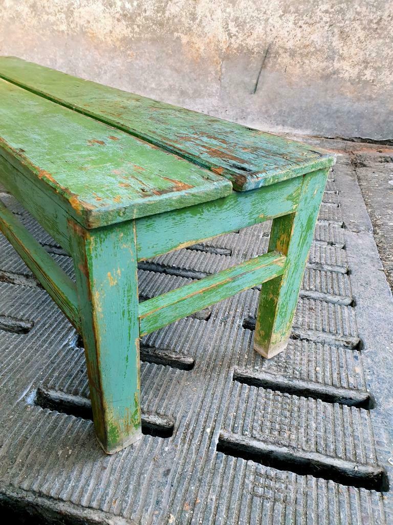 Old wooden bench sidetable green