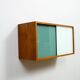 A vintage mid-century wall hung oak cabinet, green & white glass doors