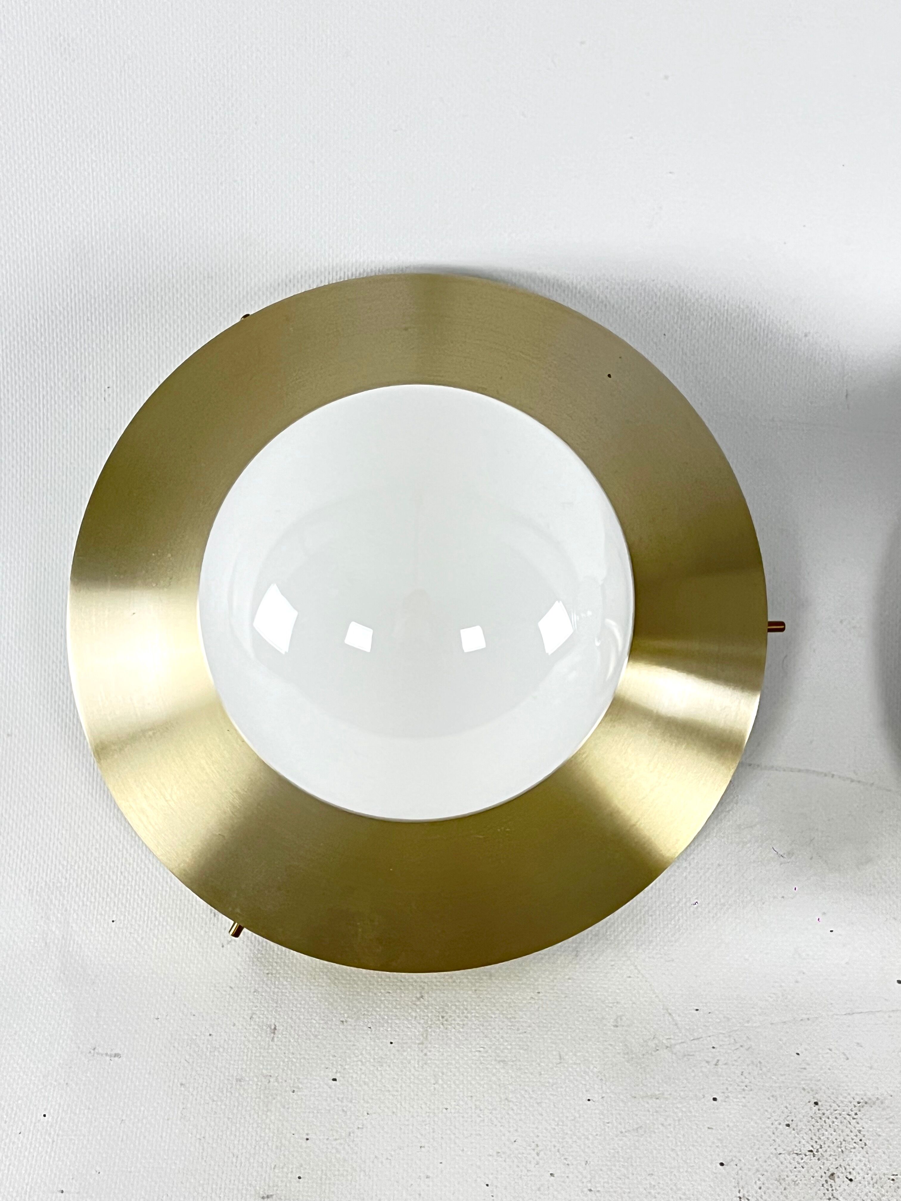 Stilux Milano, vintage round gilded aluminum wall lamps from 60s. Set of two