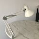 Off-white articulated architect lamp.