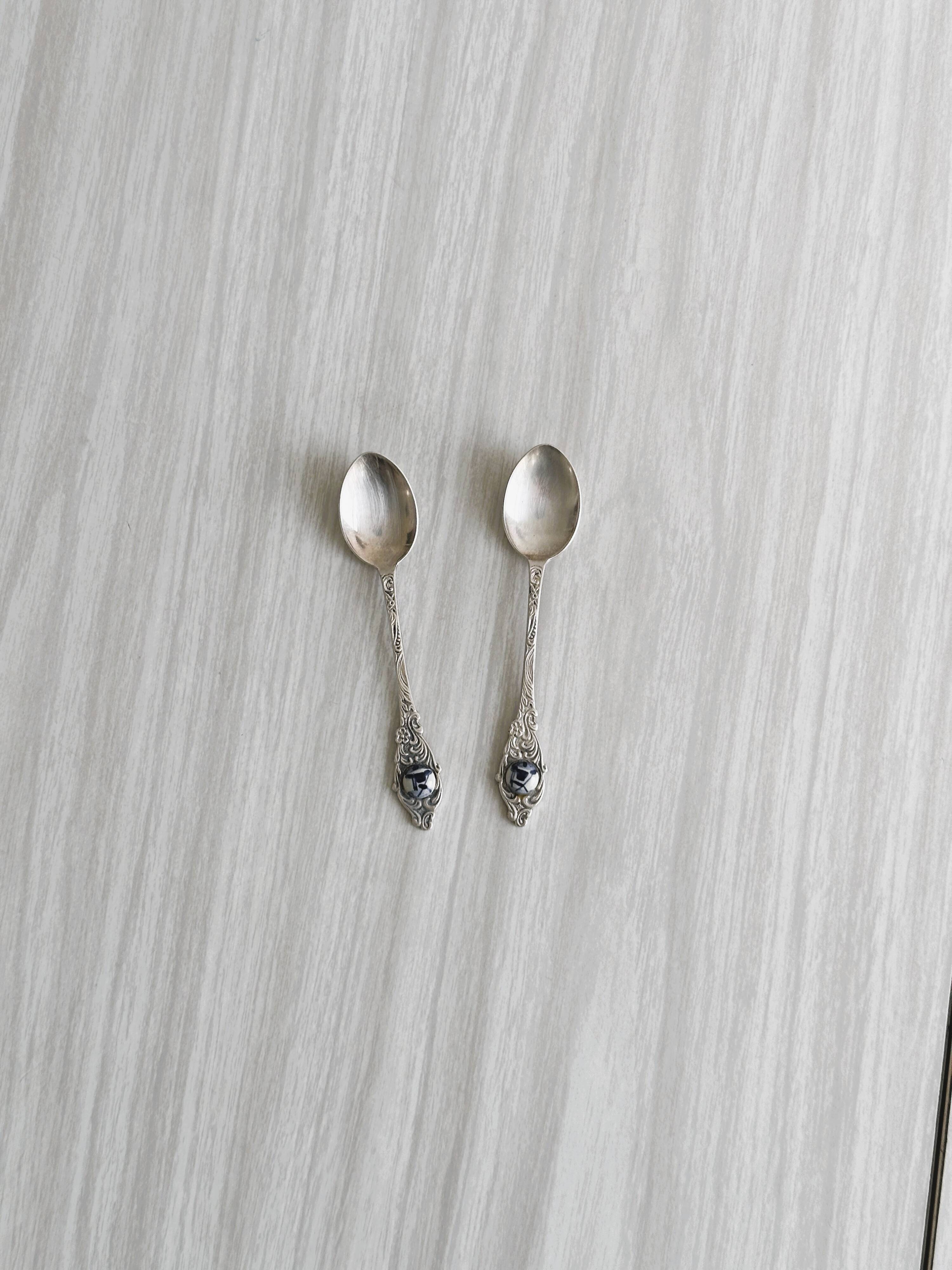Two small metal spoons