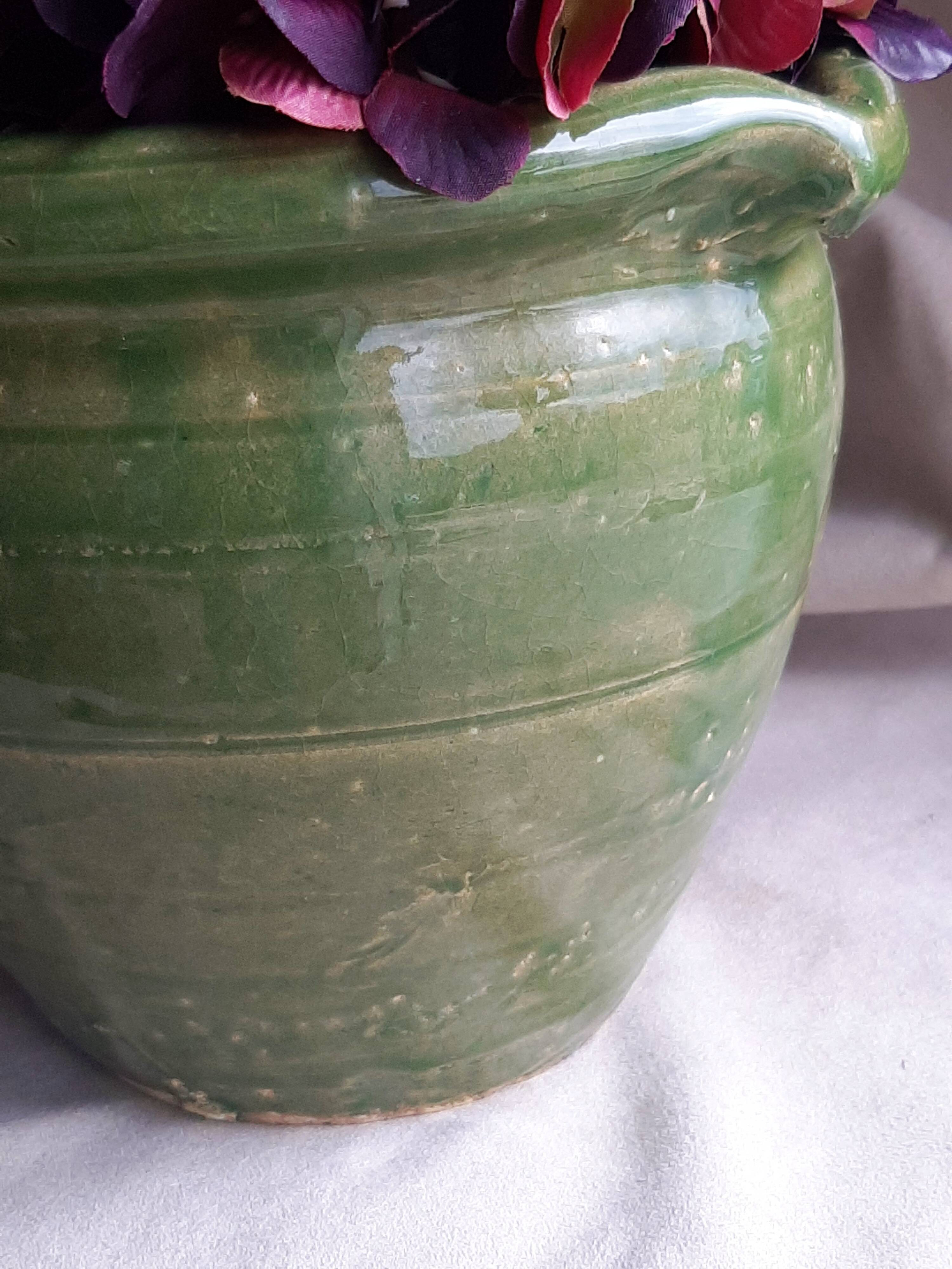 Glazed green terracotta pot.