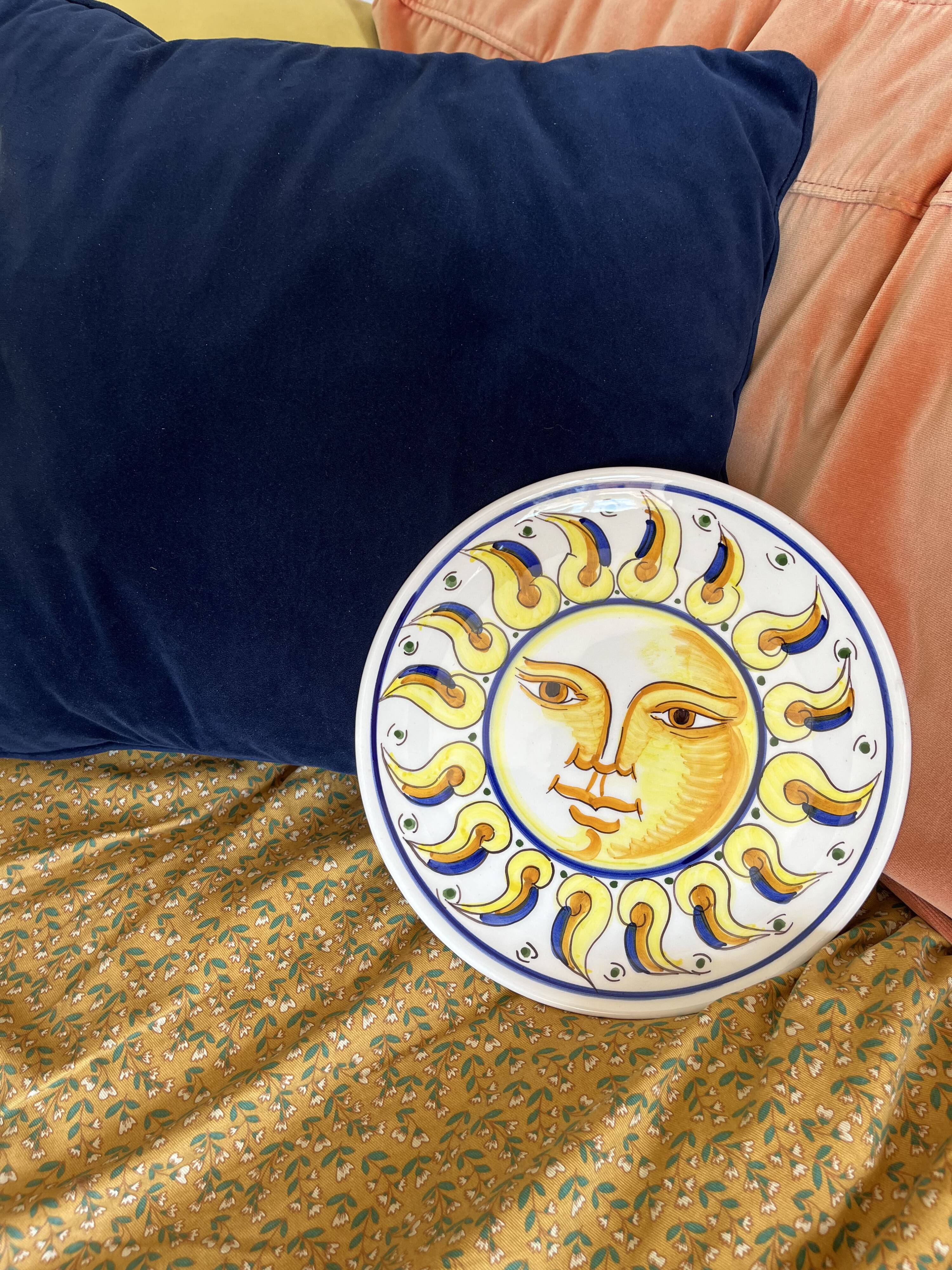 Decorative ceramic plate with sun face