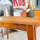 Old wooden desk or side table with compass legs